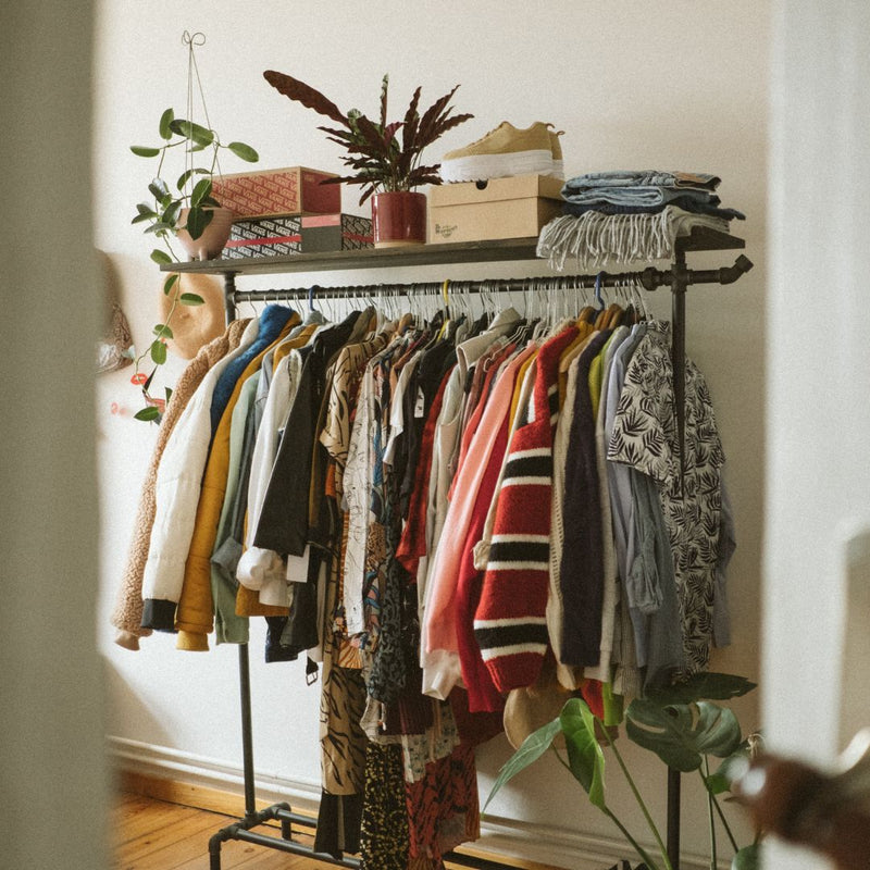 Free standing clothes rack made from dark water pipes and dark pine shelf for hanging clothes and folding clothes