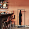 Modern clothes rack for jackets from guests in bar. free standing and sturdy iron pipes in black