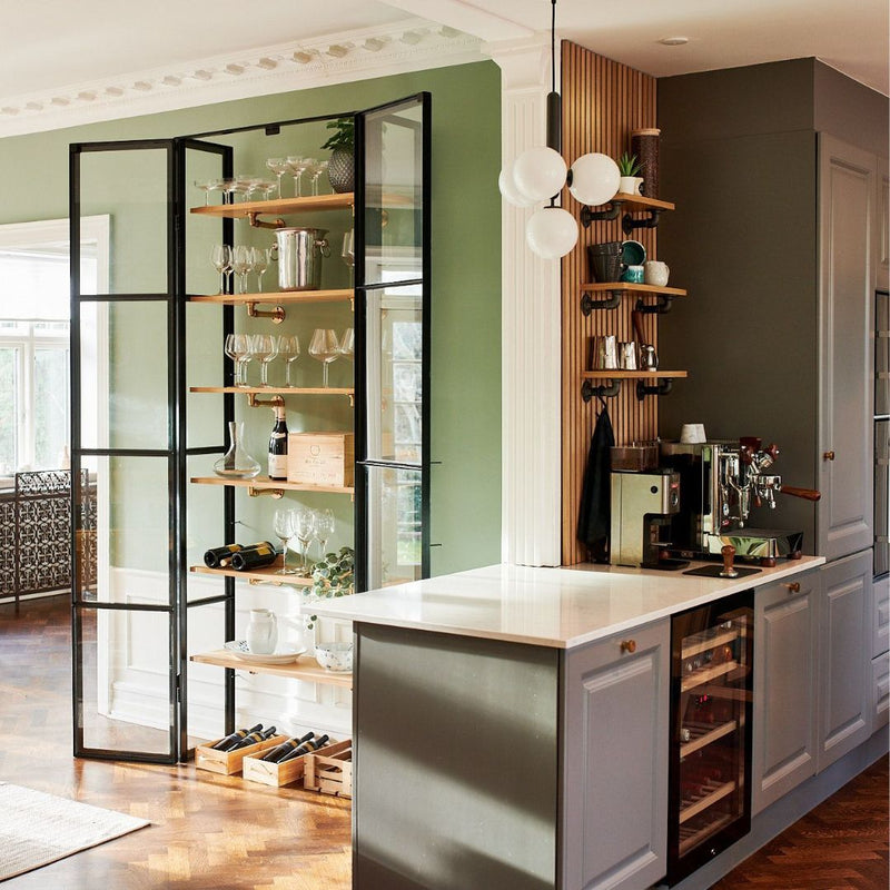 Small kitchen corner with wall mounted oak shelves with industrial supports from water pipes